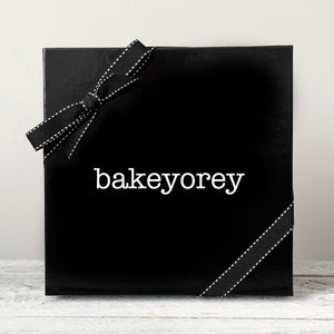 
                  
                    A black gift box with black ribbon and a white logo reading Bakeyorey
                  
                